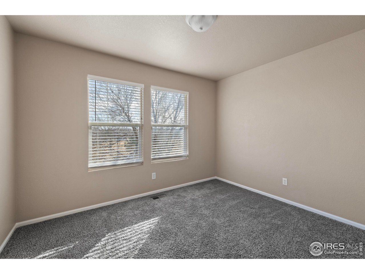 7399 Russell Circle Frederick, CO 80504 - Photo 25 of 35 an empty room with windows