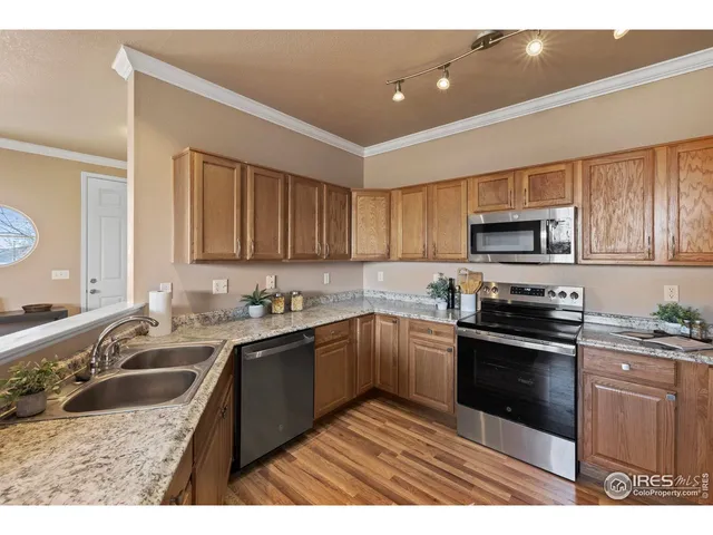 a kitchen with granite countertop a sink a stove and cabinets