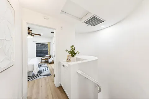 a bedroom with a bed and a potted plant