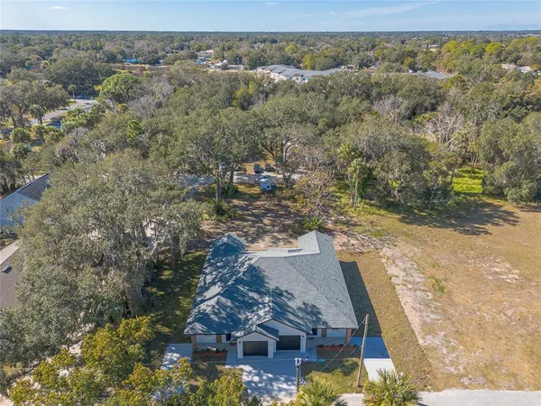 an aerial view of a house with a yard