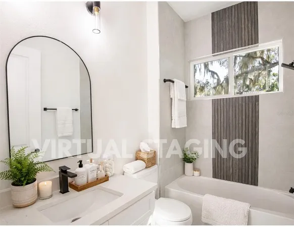 a bathroom with a double vanity mirror and a bathtub