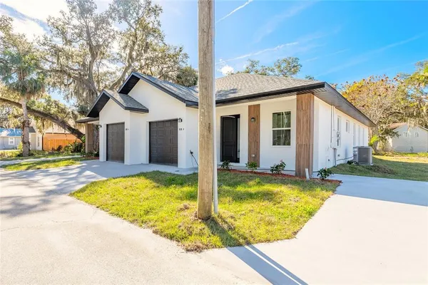 a bathroom with a granite countertop shower a toilet and a sink
