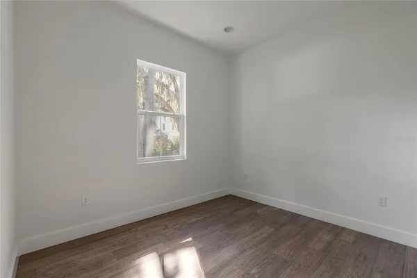 a view of an empty room with a kitchen