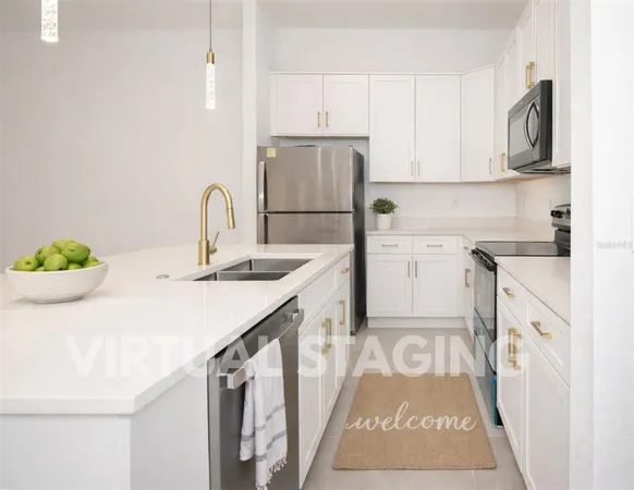 a kitchen with stainless steel appliances a refrigerator sink and microwave