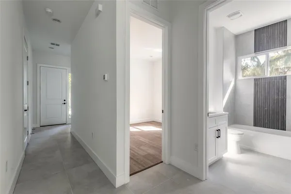 an empty room with wooden floor and a window