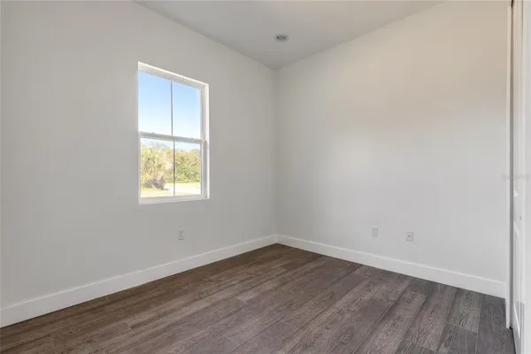 a bathroom with a granite countertop shower and a toilet