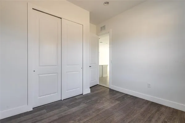 a view of a kitchen with white cabinets