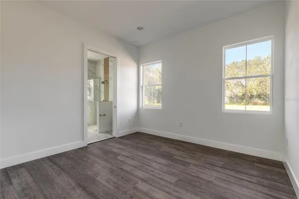 a kitchen with stainless steel appliances a refrigerator sink and white cabinets