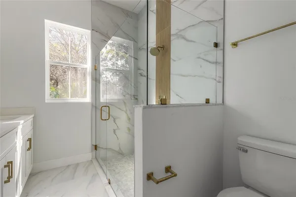 a small space with wooden floor and a window