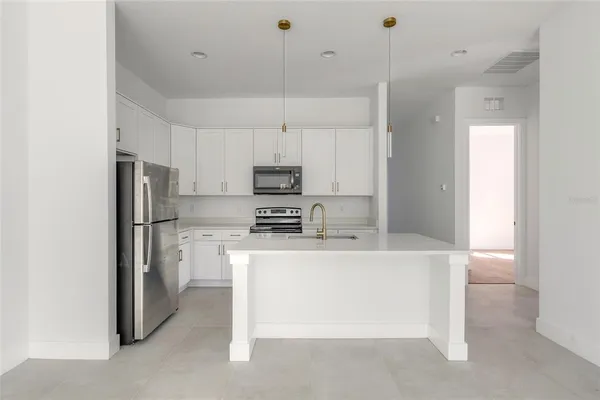a kitchen with a sink cabinets and window