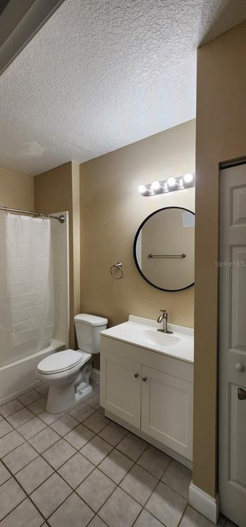 2015 Reston Road, Unit 2211 Orlando, FL 32837 - Photo 14 of 28 a bathroom with a toilet a sink and mirror