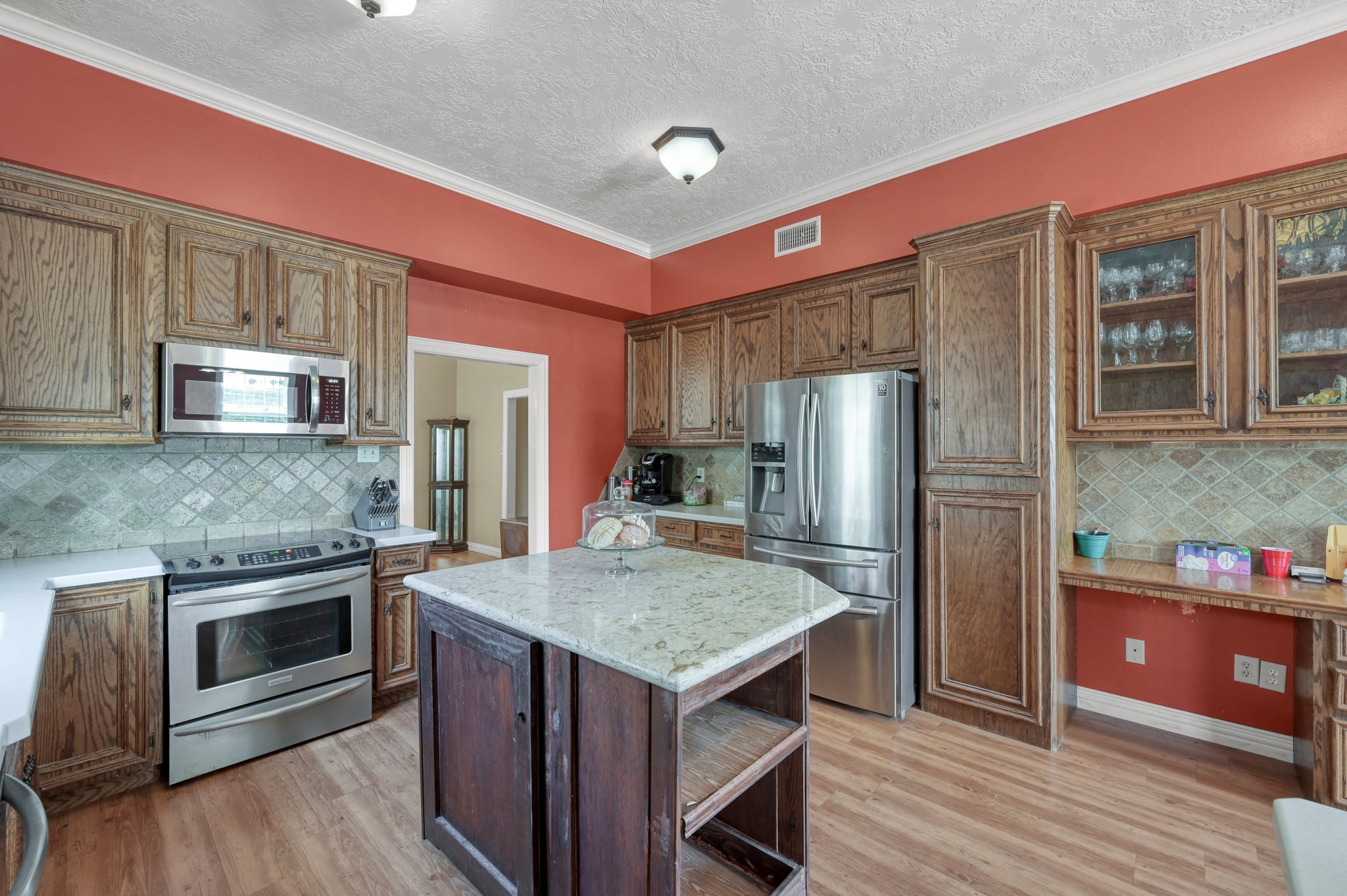 144 Wood Farm Road Huntsville, TX 77320 - Photo 11 of 35 a kitchen with stainless steel appliances granite countertop a refrigerator a stove and a wooden floors