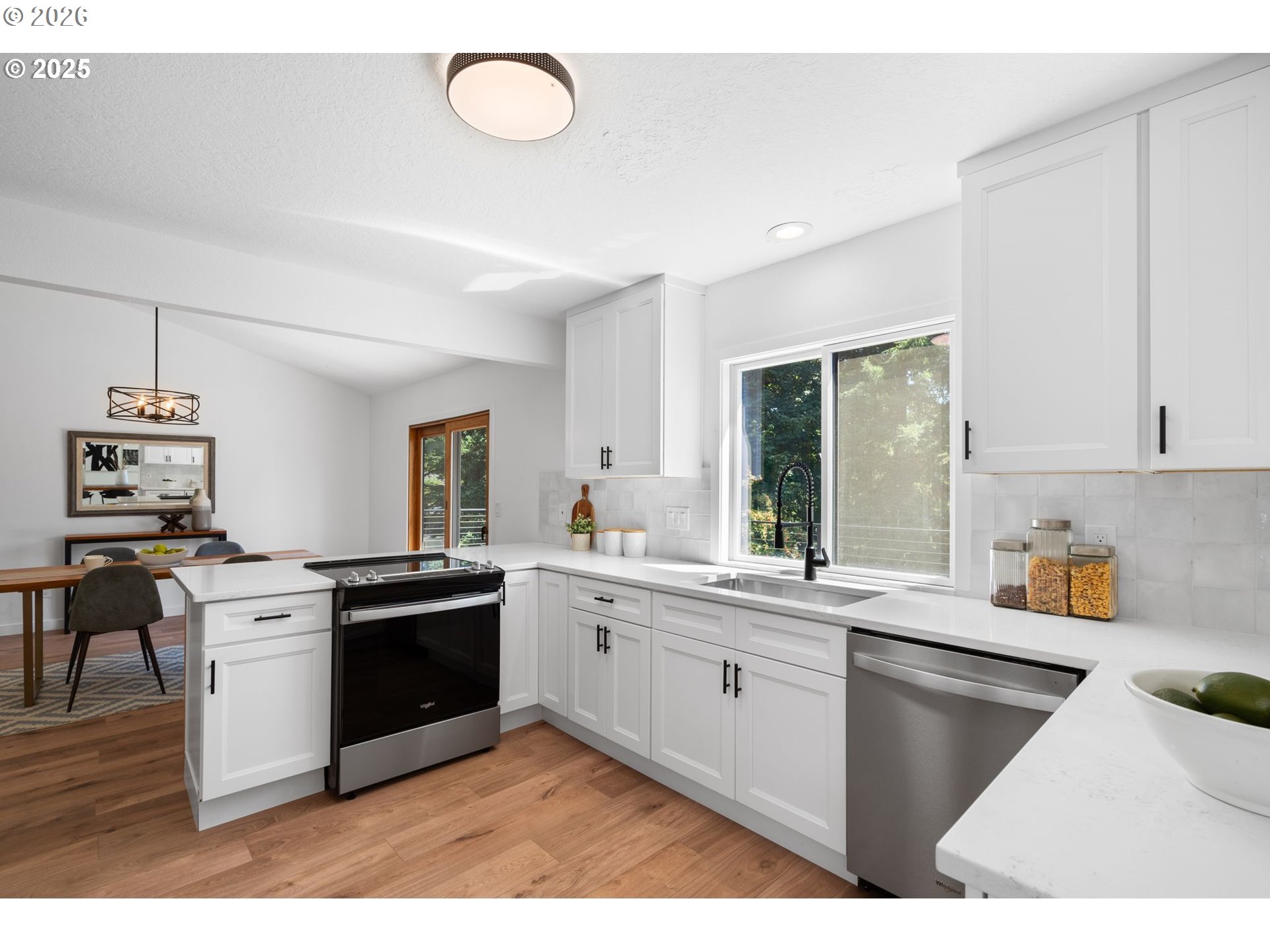 2 Falstaff Lake Oswego, OR 97035 - Photo 11 of 39 a kitchen with stainless steel appliances granite countertop a stove top oven a sink dishwasher and white cabinets with wooden floor