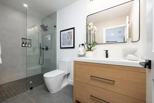 a bathroom with a toilet sink and mirror