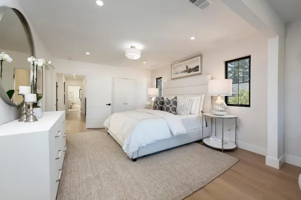 a bedroom with a bed a mirror and a desk