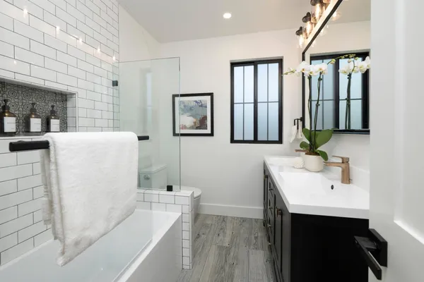 a bathroom with a sink a mirror and a bathtub