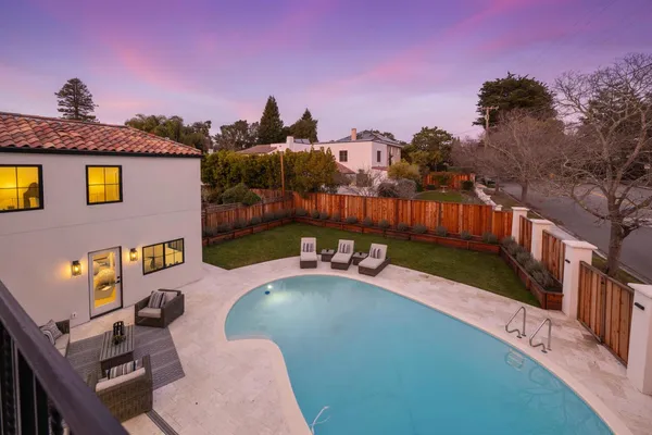 a view of a backyard with sitting area