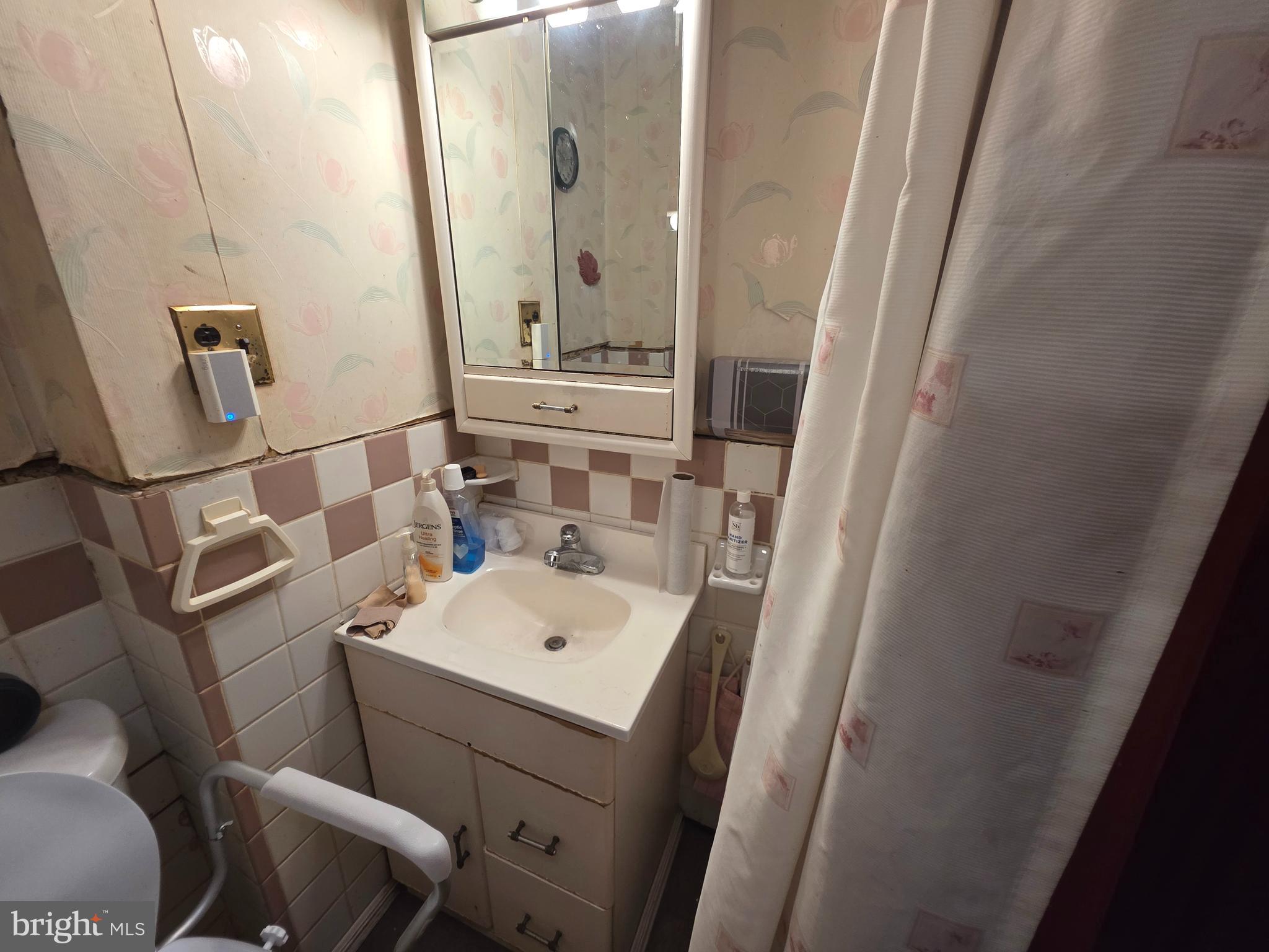 1317 East Rittenhouse Street Philadelphia, PA 19138 - Photo 13 of 16 a bathroom with a sink a toilet and shower a mirror