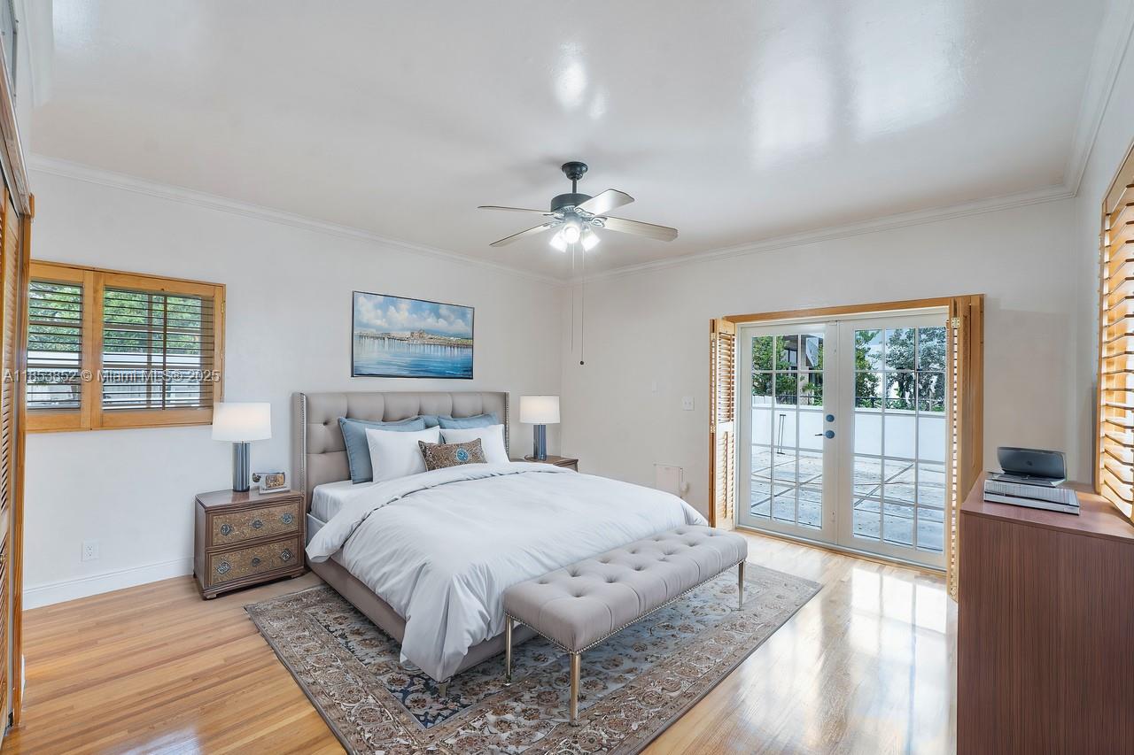 13000 Old Cutler Road Pinecrest, FL 33156 - Photo 11 of 43 a spacious bedroom with a large bed and a chandelier