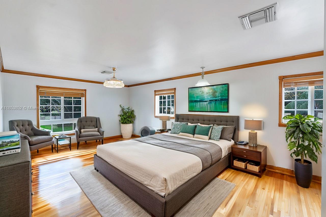 13000 Old Cutler Road Pinecrest, FL 33156 - Photo 16 of 43 a large bedroom with a large bed and a flat tv screen