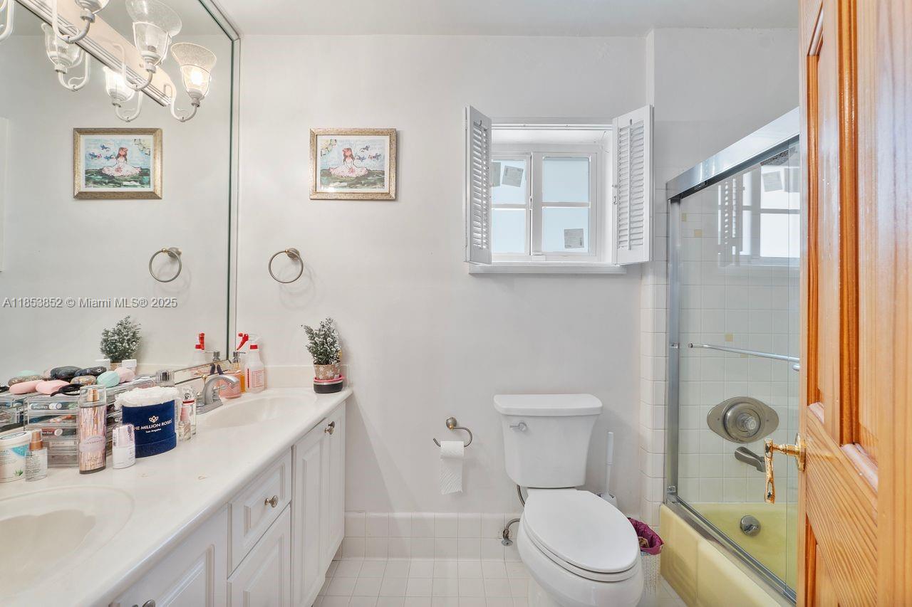 13000 Old Cutler Road Pinecrest, FL 33156 - Photo 17 of 43 a bathroom with a granite countertop sink mirror vanity and toilet