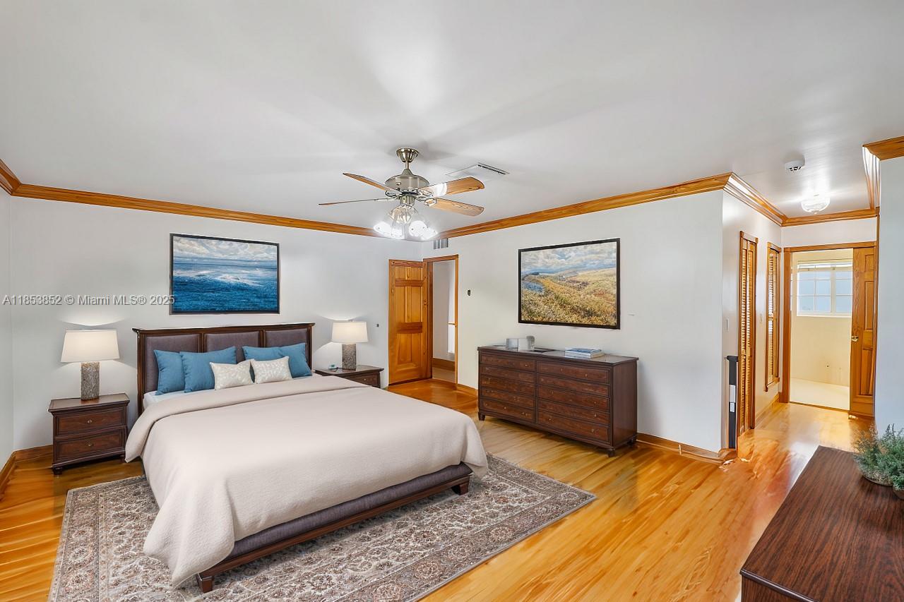 13000 Old Cutler Road Pinecrest, FL 33156 - Photo 18 of 43 a bedroom with a bed and a chandelier