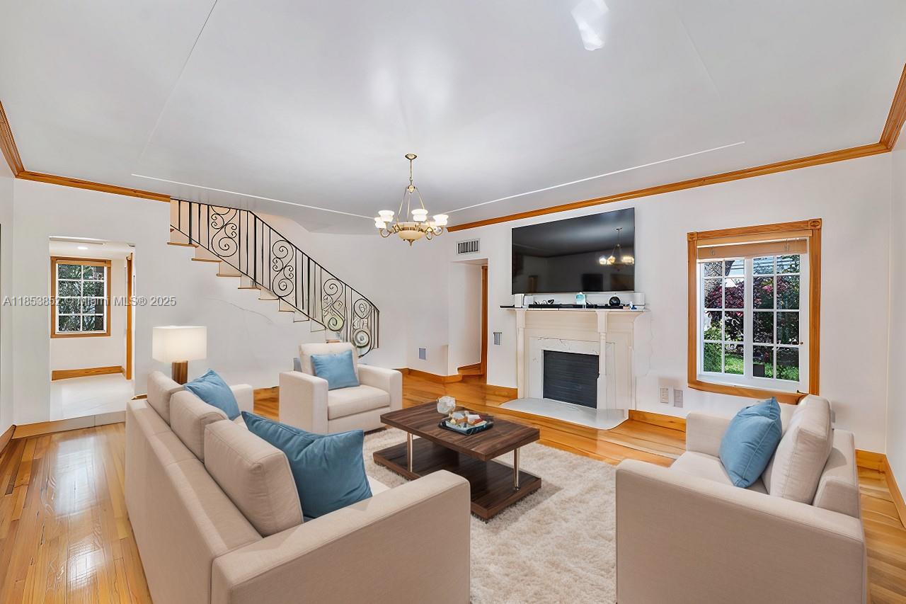 13000 Old Cutler Road Pinecrest, FL 33156 - Photo 2 of 43 a living room with furniture a fireplace and a flat screen tv