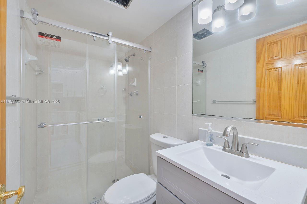 13000 Old Cutler Road Pinecrest, FL 33156 - Photo 21 of 43 a bathroom with a sink toilet and shower