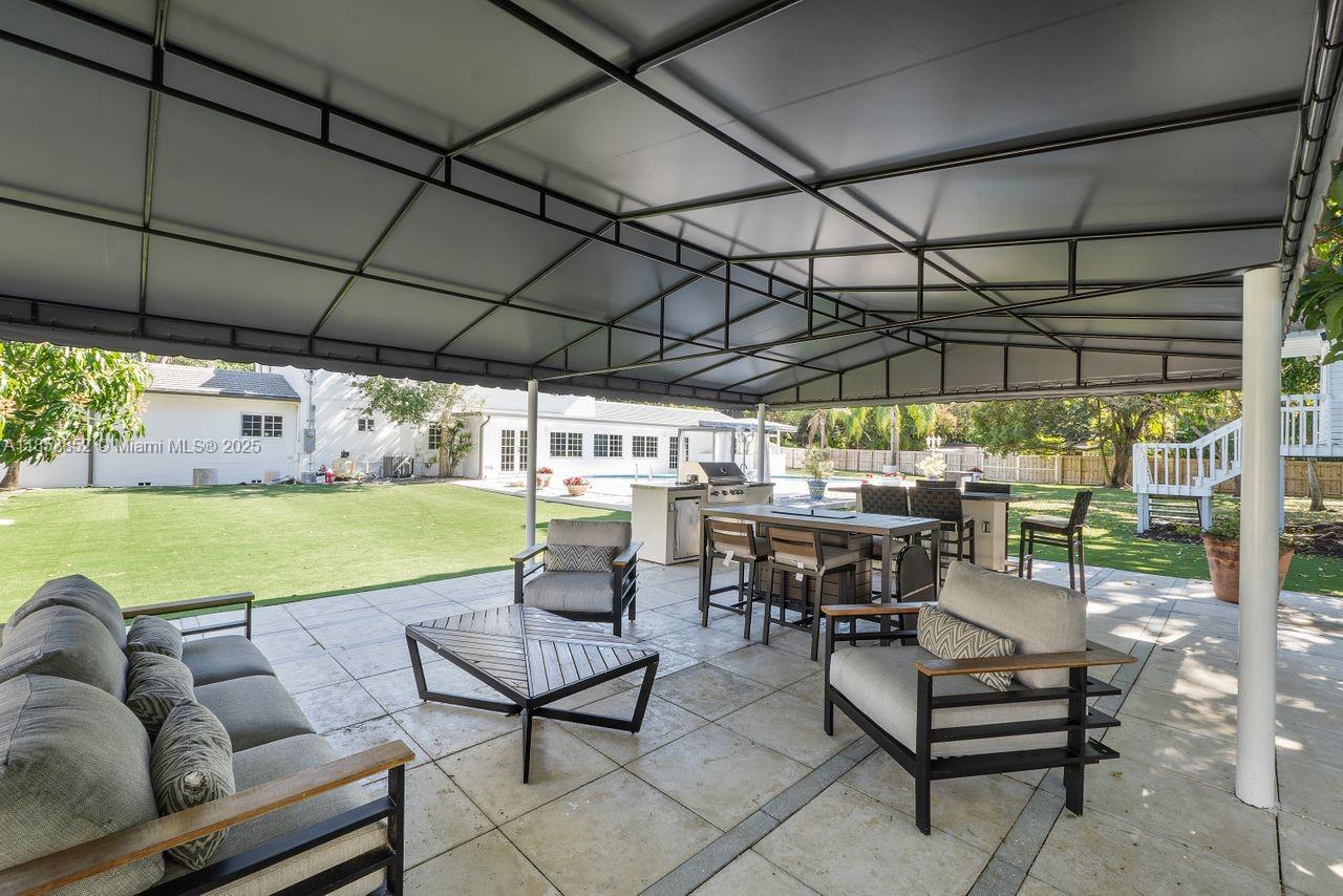 13000 Old Cutler Road Pinecrest, FL 33156 - Photo 26 of 43 a view of a swimming pool with a couches in a patio