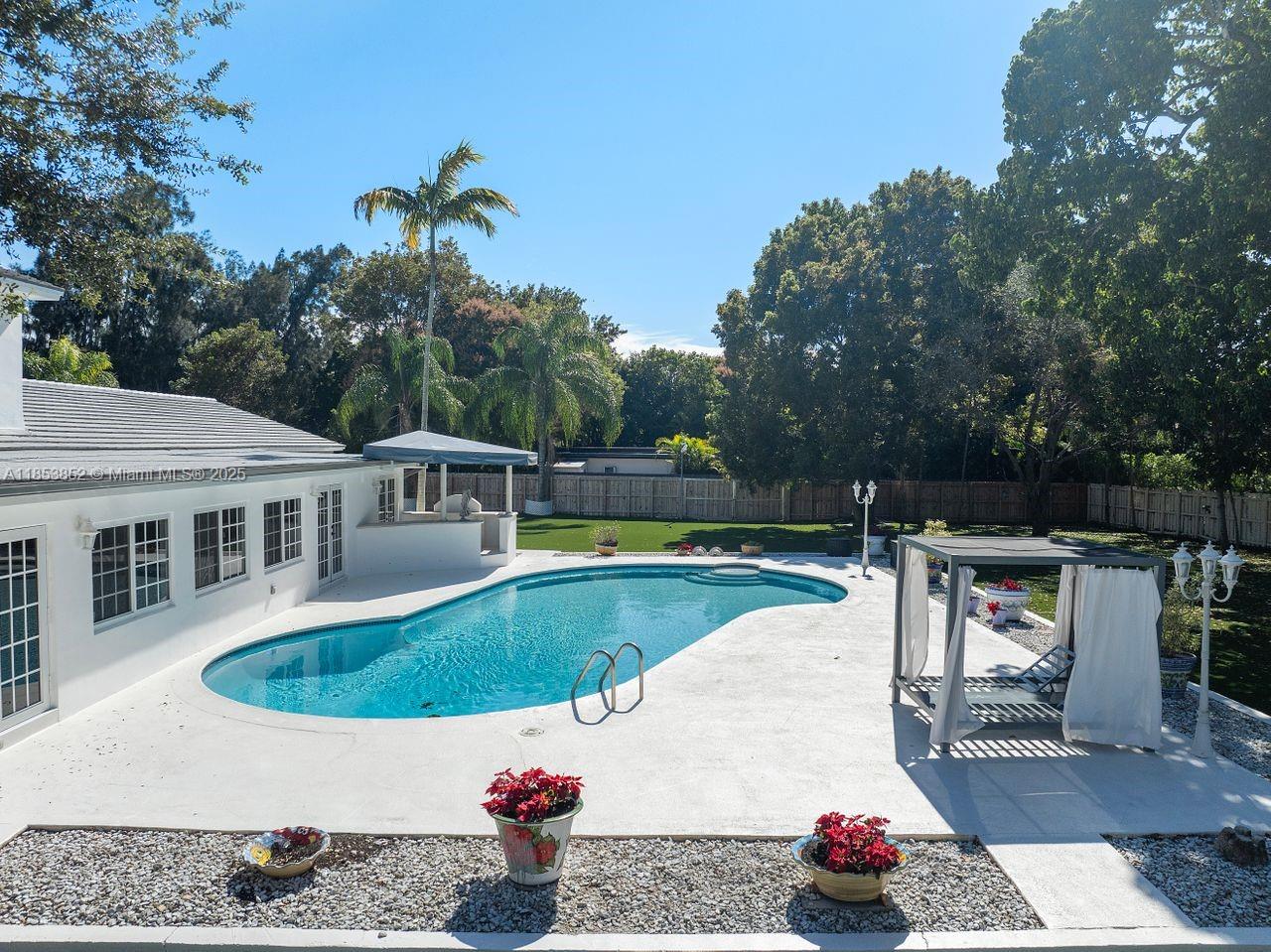 13000 Old Cutler Road Pinecrest, FL 33156 - Photo 29 of 43 a view of a swimming pool with a patio