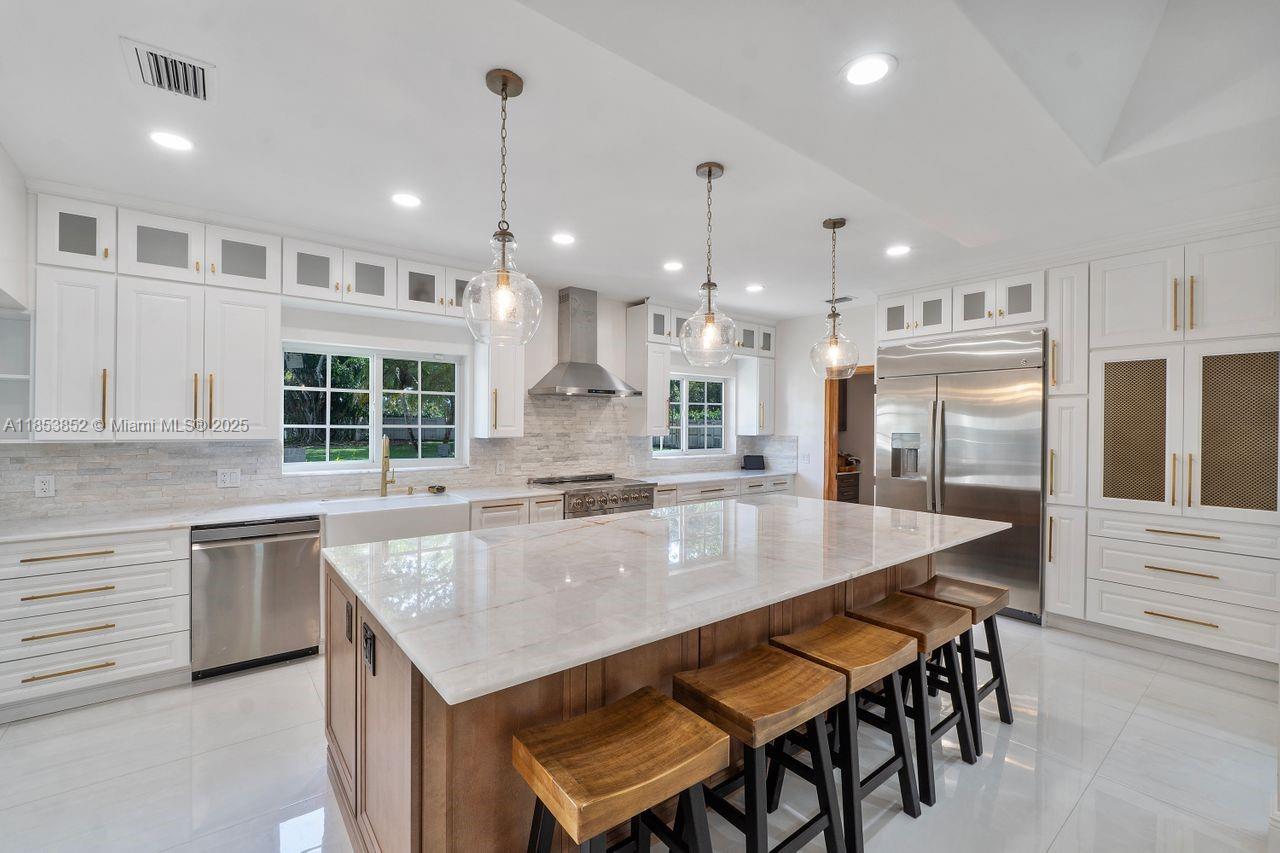13000 Old Cutler Road Pinecrest, FL 33156 - Photo 5 of 43 a large kitchen with kitchen island a large island in it