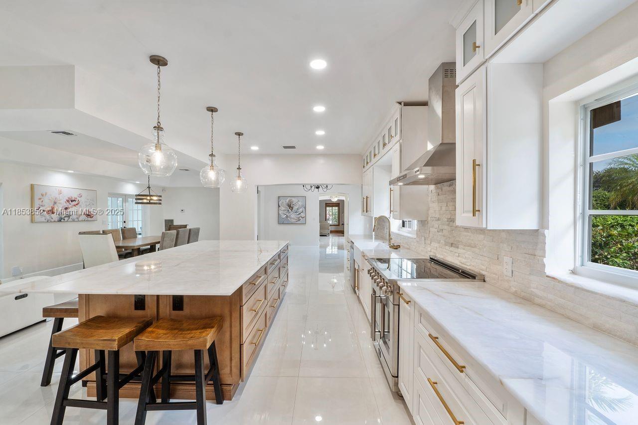 13000 Old Cutler Road Pinecrest, FL 33156 - Photo 6 of 43 a large kitchen with a table and chairs