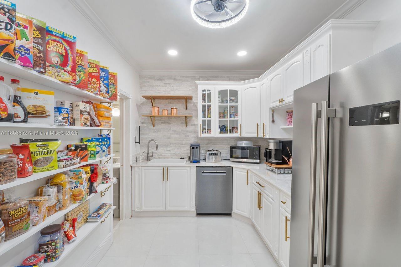 13000 Old Cutler Road Pinecrest, FL 33156 - Photo 9 of 43 a kitchen with stainless steel appliances a stove a refrigerator and a microwave