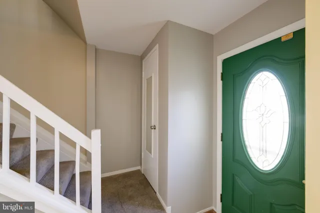 a view of a livingroom with wooden floor and a window