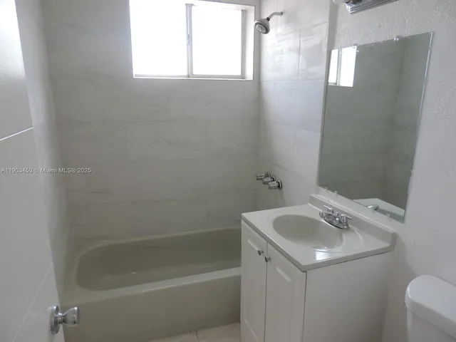 a white bath tub sitting next to a white sink