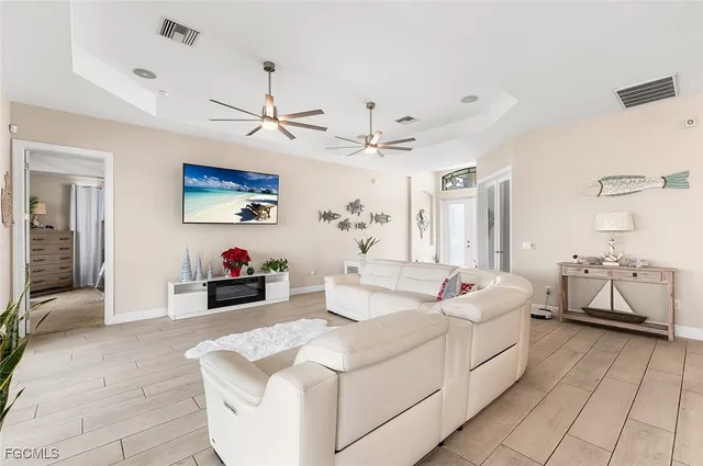 a living room with furniture and kitchen view