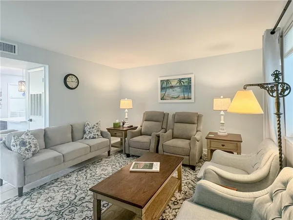 a living room with furniture and a lamp