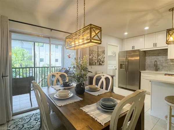 a kitchen with a stove a refrigerator and a dining table