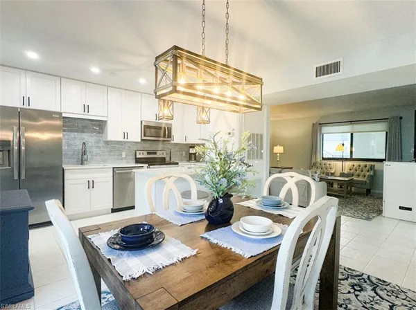 a kitchen with cabinets appliances a sink and a counter top space