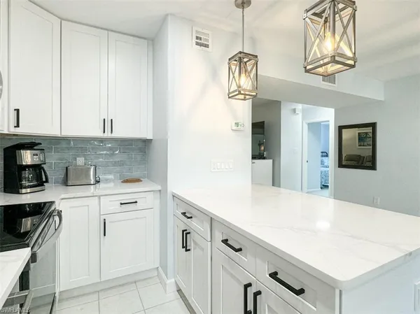 a kitchen with a cabinets a stove and a table