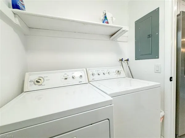a view of a dining room with furniture a chandelier and wooden floor
