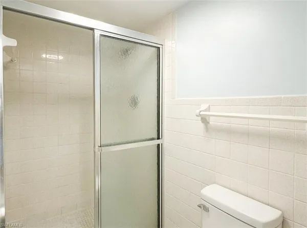 a bedroom with two beds and painting on the wall