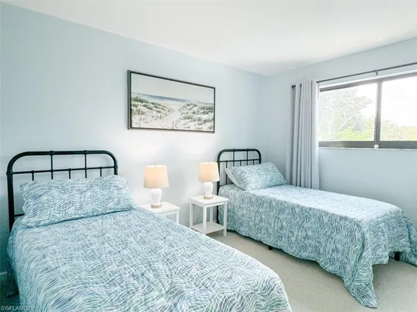 a bedroom with a bed and a night stand