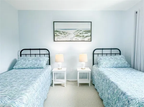 a bedroom with a bed and a painting on the wall