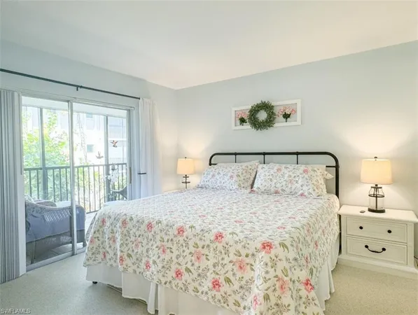 a bedroom with a large bed and a lamp