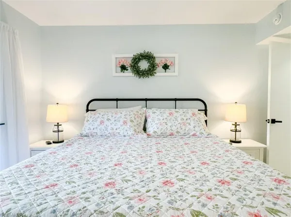 a bedroom with a bed and a night stand