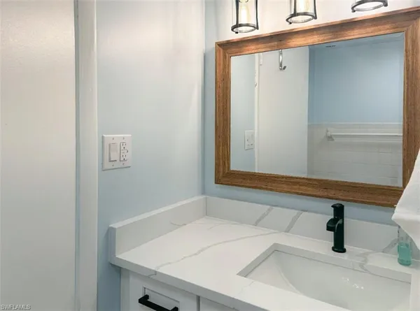 a bedroom with a bed and a flat screen tv in it