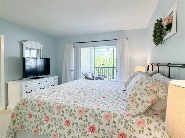 a bedroom with cabinets and flat screen tv