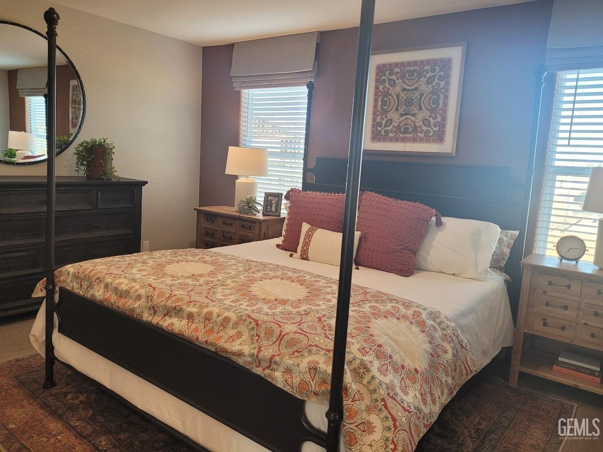 Undisclosed Address Bakersfield, CA 93313 - Photo 13 of 25 a large bed sitting in a bedroom next to a window