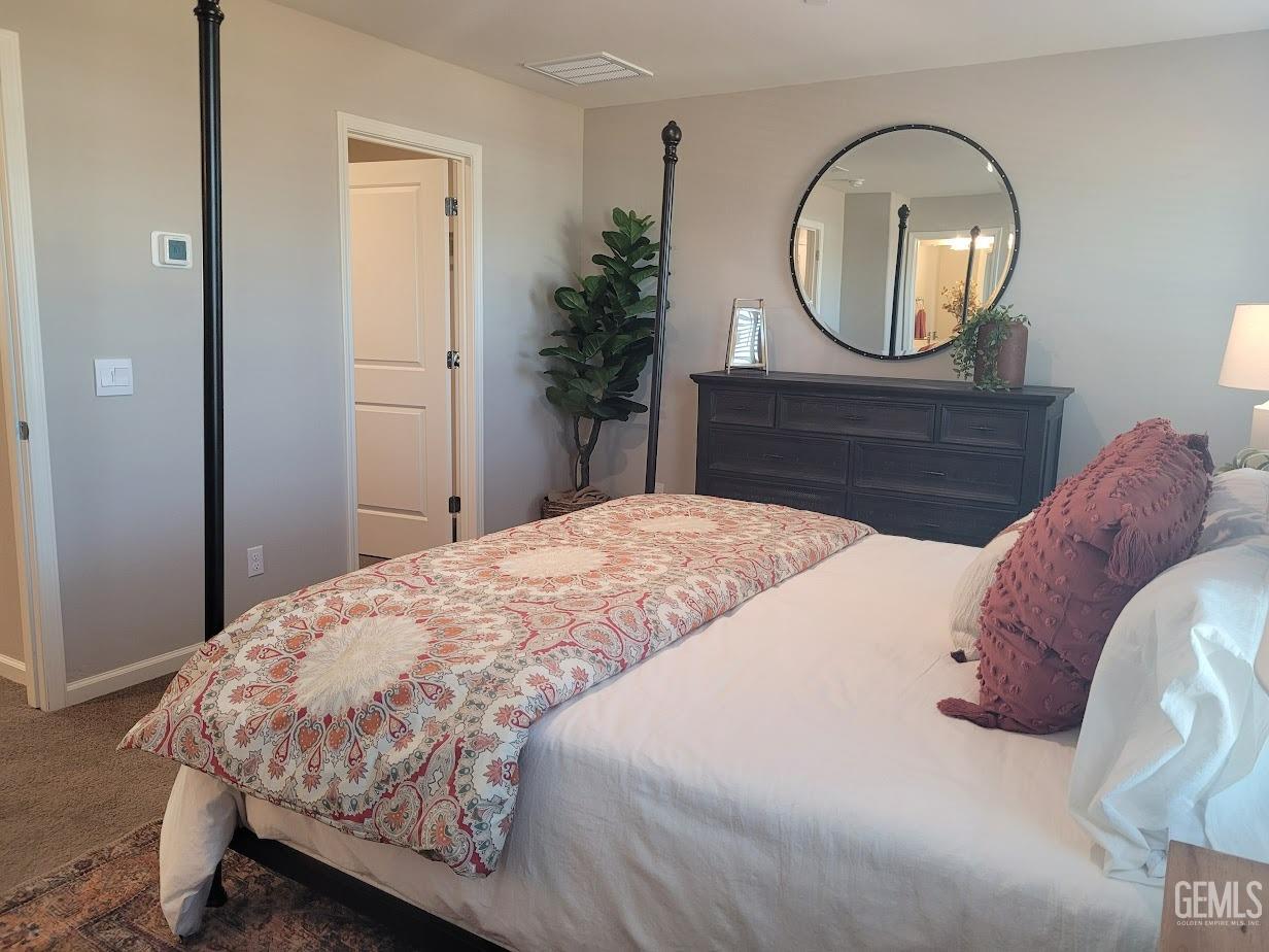 Undisclosed Address Bakersfield, CA 93313 - Photo 14 of 25 a bedroom with a bed and a mirror